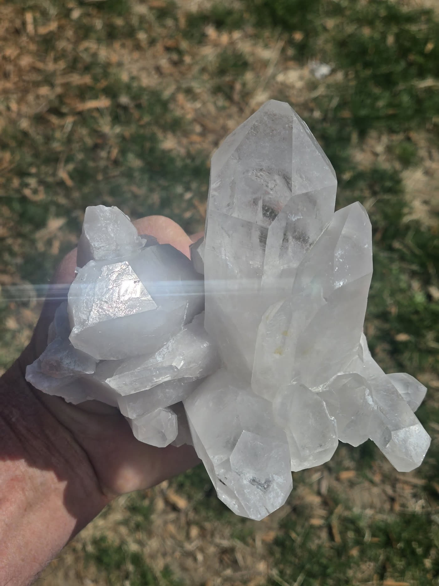 Cleaned Arkansas quartz cluster held in hand